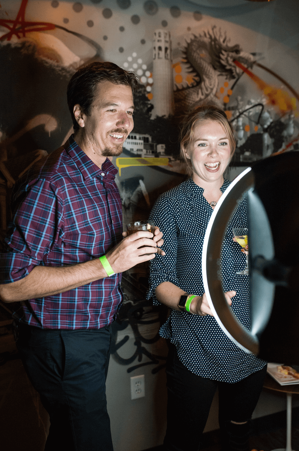 Two people standing at bar using Simple Booth