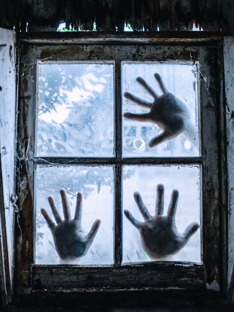 3 hands on frosty old window to use as a creepy photo booth background