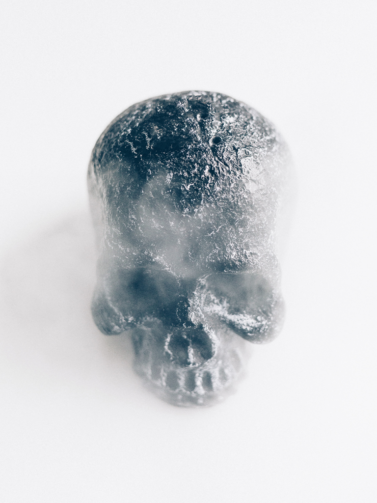 metallic skull on white photo booth background and fog