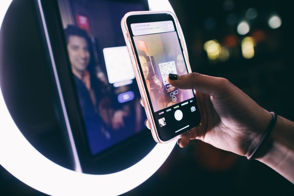 person getting photo from social photo booth