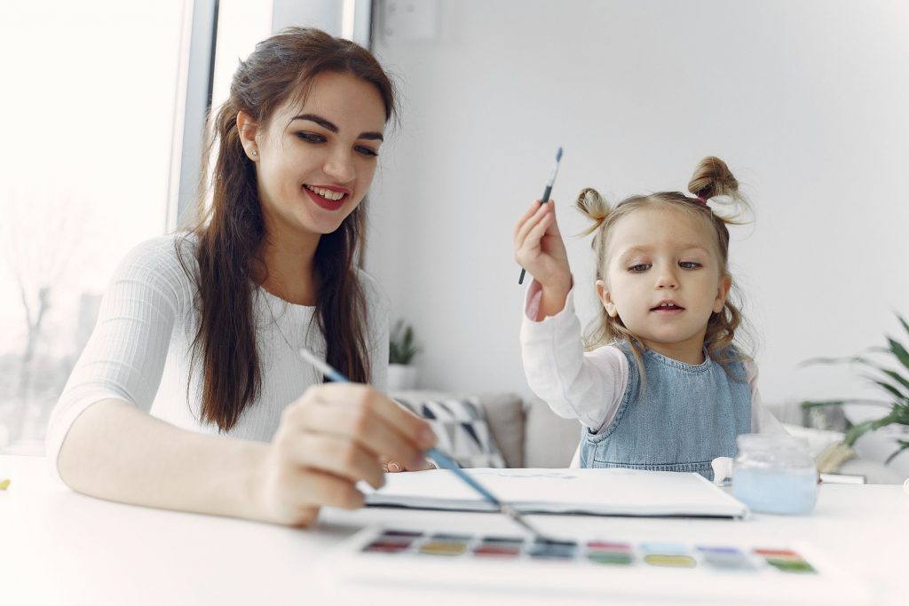 two kids painting while at home isolating