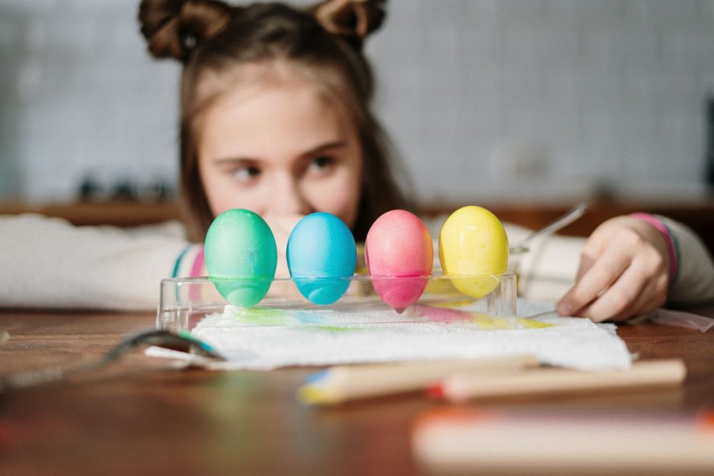 girl looking at easter eggs