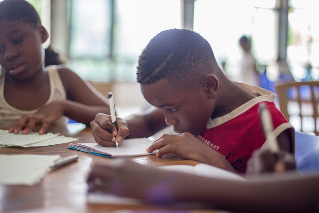 Kids writing letters to loved ones while at home