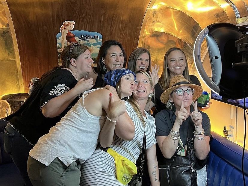 A group poses in front of HALO for a photo