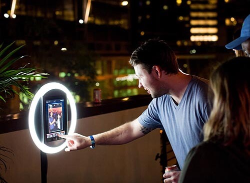 People interacting with a selfie station