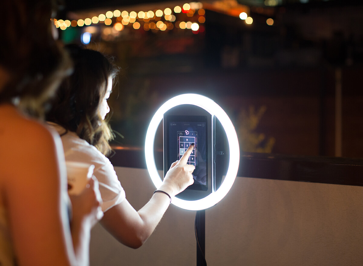 People interacting with a selfie station