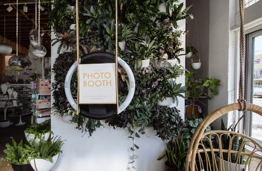 Selfie station in a boutique store with floral backdrop